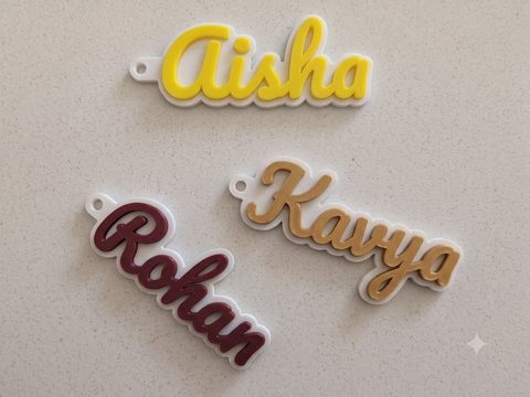Three printed Bombay 3D Studio keychains reading Aisha, Kavya and Rohan